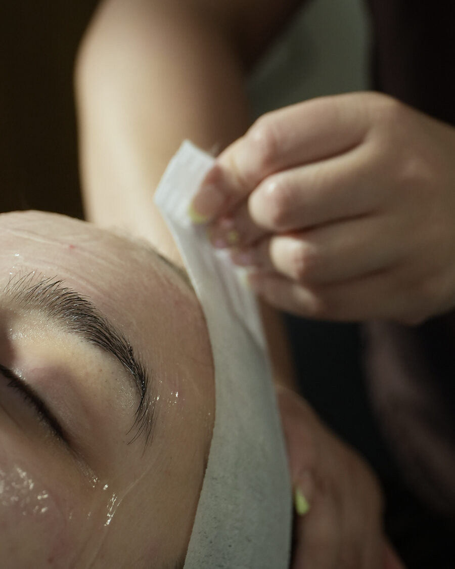 A wax strip lifted during a brow shaping